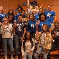 Image of student workers, TRIO advisors and directors with Louie holding up the 'L' for Lakers